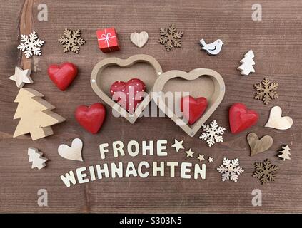 Frohe Weihnachten, Merry Christmas with creative wooden ornaments Stock Photo