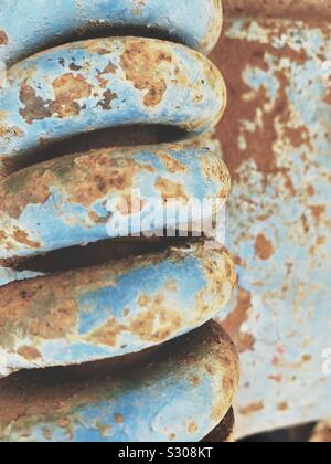 Rusted metal coil with peeling paint Stock Photo