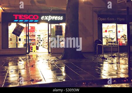 A Tesco Express store on a rainy night Stock Photo