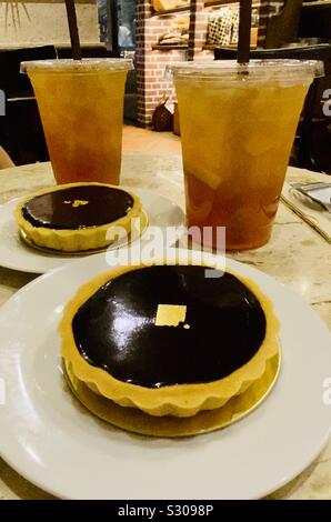 Chocolate tarts and drinks on café table Stock Photo
