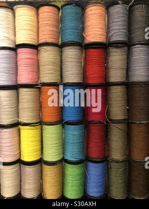 Colorful spools of thread in many different bright colors Stock Photo