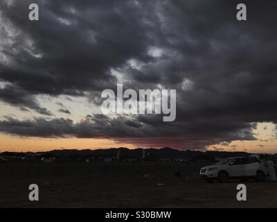 Dark clouds in horizon, during sunset Stock Photo