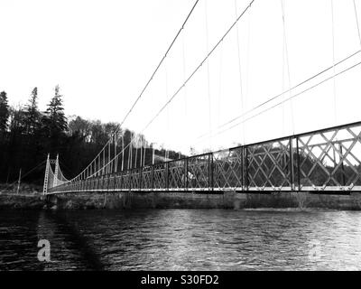 Suspension footbridge over the River Spey at Aberlour In Monochrome Stock Photo