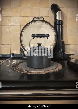 Kettle boiling on hob on Aga cooking range Stock Photo