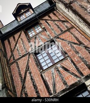 Decorative brickwork patterns on facade of medieval half-timbered 15th century house in Place Plumereau, Tours, central France. Stock Photo