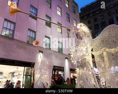 The iconic angels are in channel Gardens at Rockefeller Center during the holiday season, NYC, USA Stock Photo