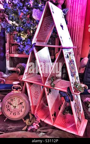 Alice in the Palace at Blenheim Palace Christmas 2019 - Mad Hatters Tea Party Table with the house of cards and clock Stock Photo