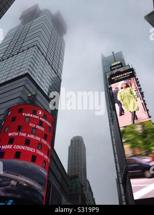 Billboards and skyscrapers in times square on a foggy evening, NYC, USA Stock Photo