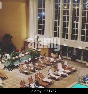 Lounge chairs in the evening by the indoor pool and one of the two hot tubs, Borgata Hotel Casino and Spa, Atlantic City, New Jersey, United States Stock Photo