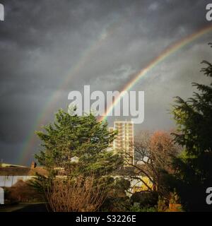 Rainbow in a stormy sky over a tower block, Tottenham, London UK Stock Photo