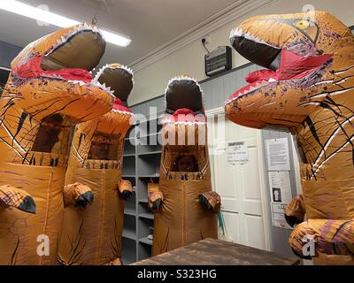 T. rex dinosaurs standing in a bakery Stock Photo
