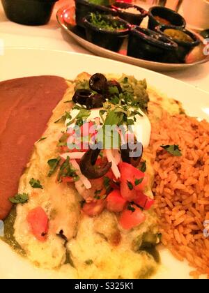 Flat lay  close up of a gourmet Mexican entrée of enchiladas at a white tablecloth restaurant, USA Stock Photo