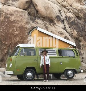 VW Bus Camper van pop up with woman at Joshua Tree National Park Stock Photo