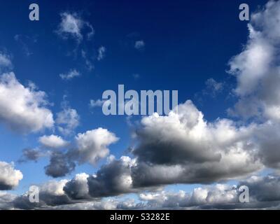 Cumulus clouds against blue sky. Stock Photo