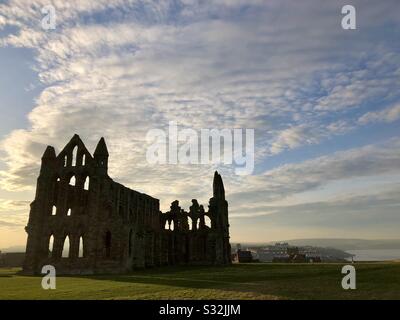 Whitby abbey in silhouette against a cloud spotted sky. Stock Photo