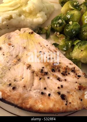 Flat lay of a gourmet meal of grilled swordfish on a fine China plate Stock Photo