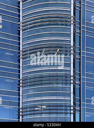 Abstract of large glass building with blue sky reflections
