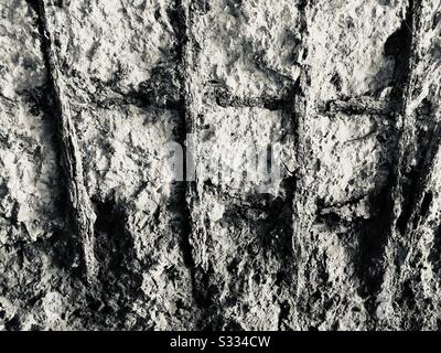Crumbling concrete wall with steel wire reinforcements Stock Photo