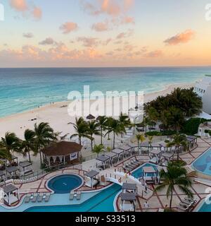 Looking out over the pool and beach from a balcony at sunset, Hyatt Zilara, Cancun, Mexico Stock Photo