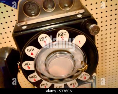 Vintage Rotary dial payphone is located in a phone booth, United States Stock Photo