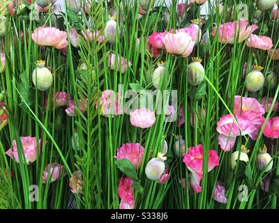 A full frame nature background image of realistic, artificial wild flowers in a meadow with copy space Stock Photo