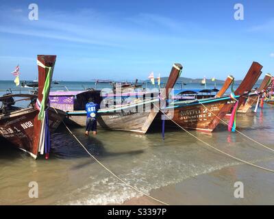 Long-tail boats on Ao Nang beach in Thailand Stock Photo
