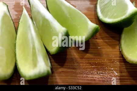 Sliced limes on a cutting board. Stock Photo