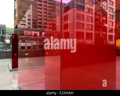 LOS ANGELES, CA, JAN 2020: view through transparent pink and red plexiglass art installation outside the Museum of Contemporary Art in Downtown Stock Photo