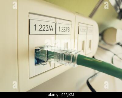 An Ethernet computer cable plugged into a port. Stock Photo