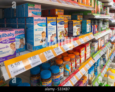 Children’s vitamins on sale and displayed on shelves in a shop. Stock Photo