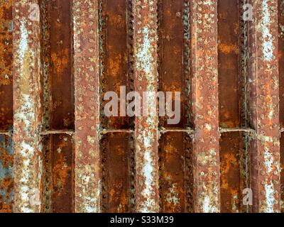 Rusty steel I beams laid out under the El train in Chicago Stock Photo