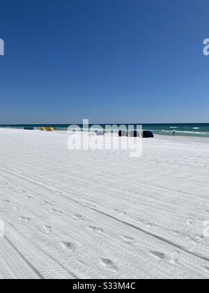 White sand beach on a winters day with beach huts and view of emerald water of the Gulf of Mexico Stock Photo