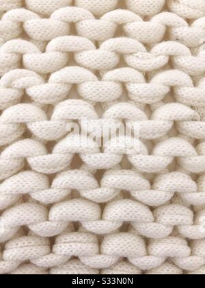 A close up background of chunky knit arran wool or yarn Stock Photo