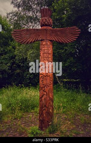 Twelve foot high totem pole in the Saltings nature conservation area in Old Kilpatrick. It is covered in designs based on local history and wildlife by pupils from Gavinburn Primary School. Stock Photo