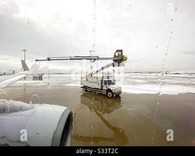 Deicing of American Airlines airplane. Stock Photo
