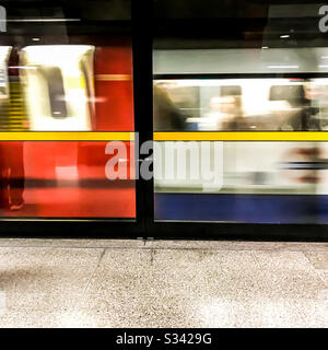 A London Underground train arriving at station platform Stock Photo