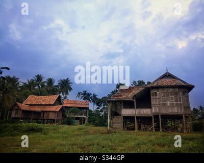 Abandoned traditional Malay kampung houses by the beach at twilight in Batu Rakit, Terengganu, Malaysia Stock Photo