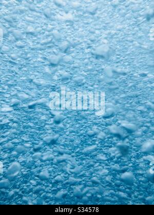 Bubbles in water floating up to the surface. Stock Photo