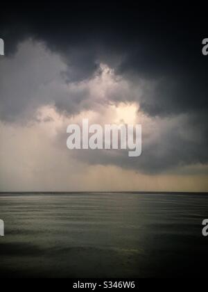 A morning rain squall over the ocean at Batu Ferringhi, Penang, Malaysia Stock Photo