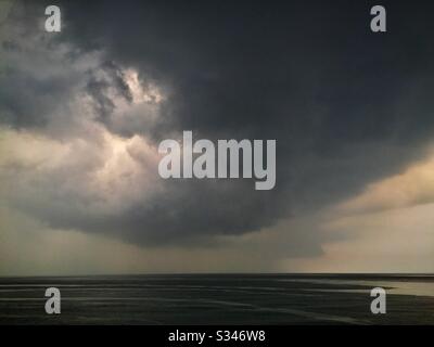 A morning rain squall over the ocean at Batu Ferringhi, Penang, Malaysia Stock Photo