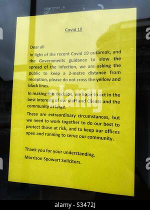 A sign in the window of a solicitors in South London outlining social distancing on the premises, March 18 2020 Stock Photo