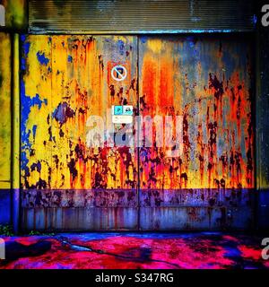A rusting painted garage door in Batu Ferringhi, Penang, Malaysia Stock Photo