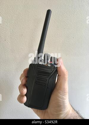Handheld walkie talkie in mans hand Stock Photo