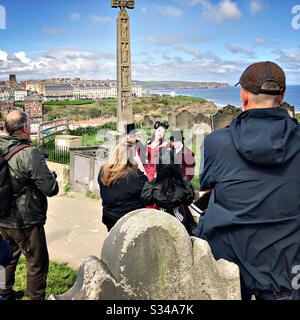 Photographers gather round a group of people dressed in costume during the Whitby Goth Weekend cosplay event Stock Photo