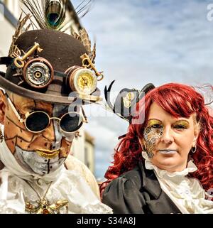 People in creative costumes during a cosplay event. Whitby Goth Weekend. Man and woman steampunk couple Stock Photo