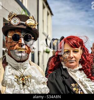 People in creative costumes during a cosplay event. Whitby Goth Weekend. Man and woman steampunk couple Stock Photo