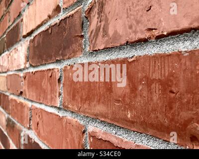 Angled view of a red brick wall Stock Photo