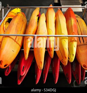 Colourful canoes stored at a small marina. Roker Marina, Sunderland, North East England. Stock Photo