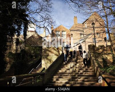 Architecture of Durham City, North East England. People use steps leading to Bow Lane from Kingsgate Bridge. Stock Photo