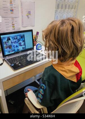 Boy attending an online Cub Scout meeting with his pack over WebEx during UK Coronavirus lockdown. Stock Photo
